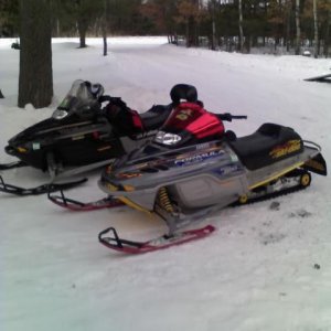 me and the wifes sleds in sherrys yard in spooner