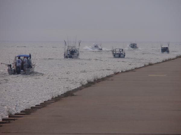 142 Charter boats headed out for evening fishing on Lake Michigan, Manistee Michigan 2010