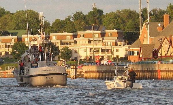 Coast Guard towing sheriff back. Grand Haven Channel.