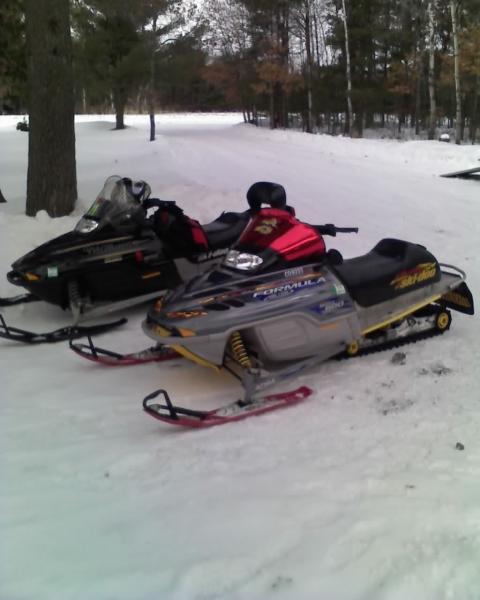 me and the wifes sleds in sherrys yard in spooner